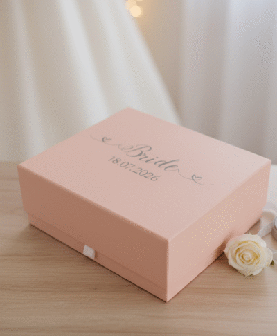 Elegantly displayed pink custom gift box for a bride, featuring "Bride" and the wedding date "18.07.2026" on the lid, perfect for bridal shower gifts or wedding morning preparations.