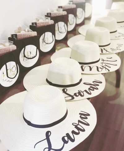 personalised hats for hen do with names and ribbon