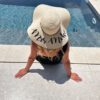 Wide-brimmed straw-style sun hat personalised with “Mrs [Surname]” text – perfect honeymoon and bride to be accessory.