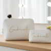Personalised ivory makeup bags (large and small) with gold 'Gabrielle' script. Perfect as bridesmaid gifts, wedding favours, or custom bridal party accessories. Ideal for 'Will you be my bridesmaid?' proposals and bachelorette party keepsakes.