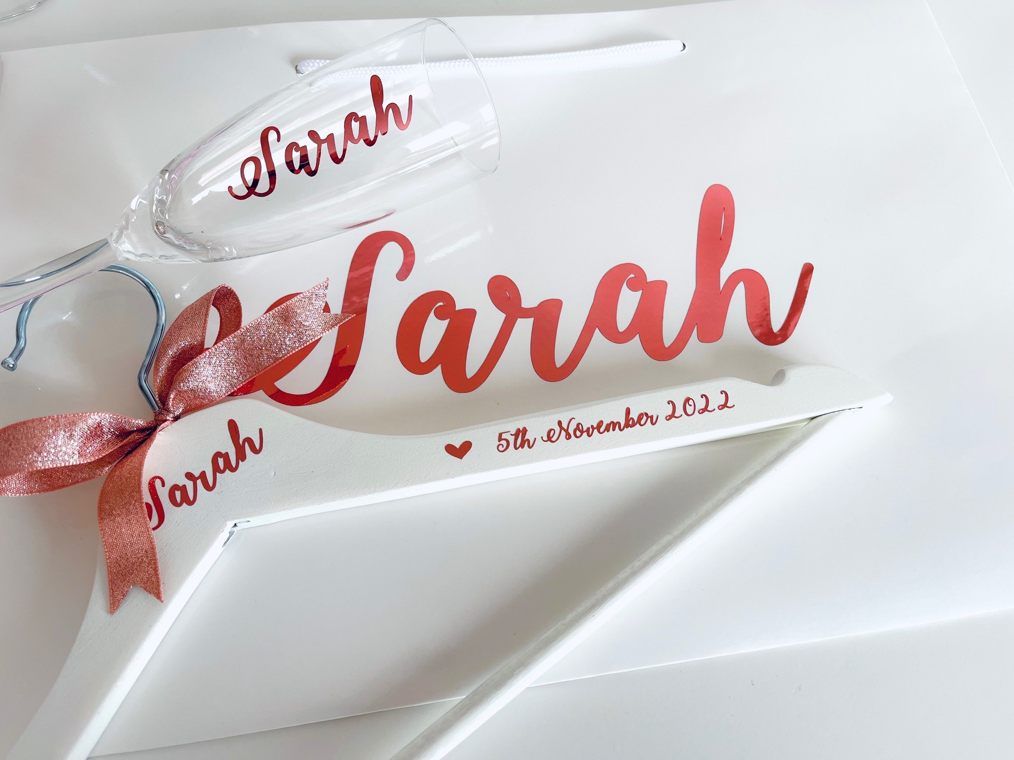 Rose gold bridesmaid hanger, flute and gift bag